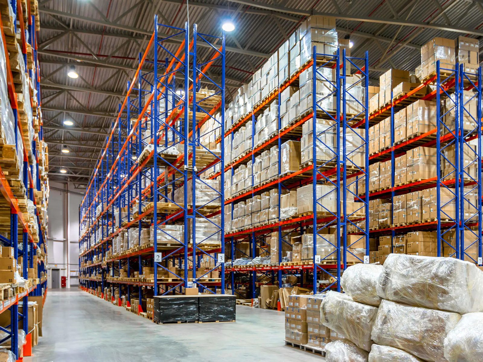 Warehouse aisle with full racking of palletized merchandise